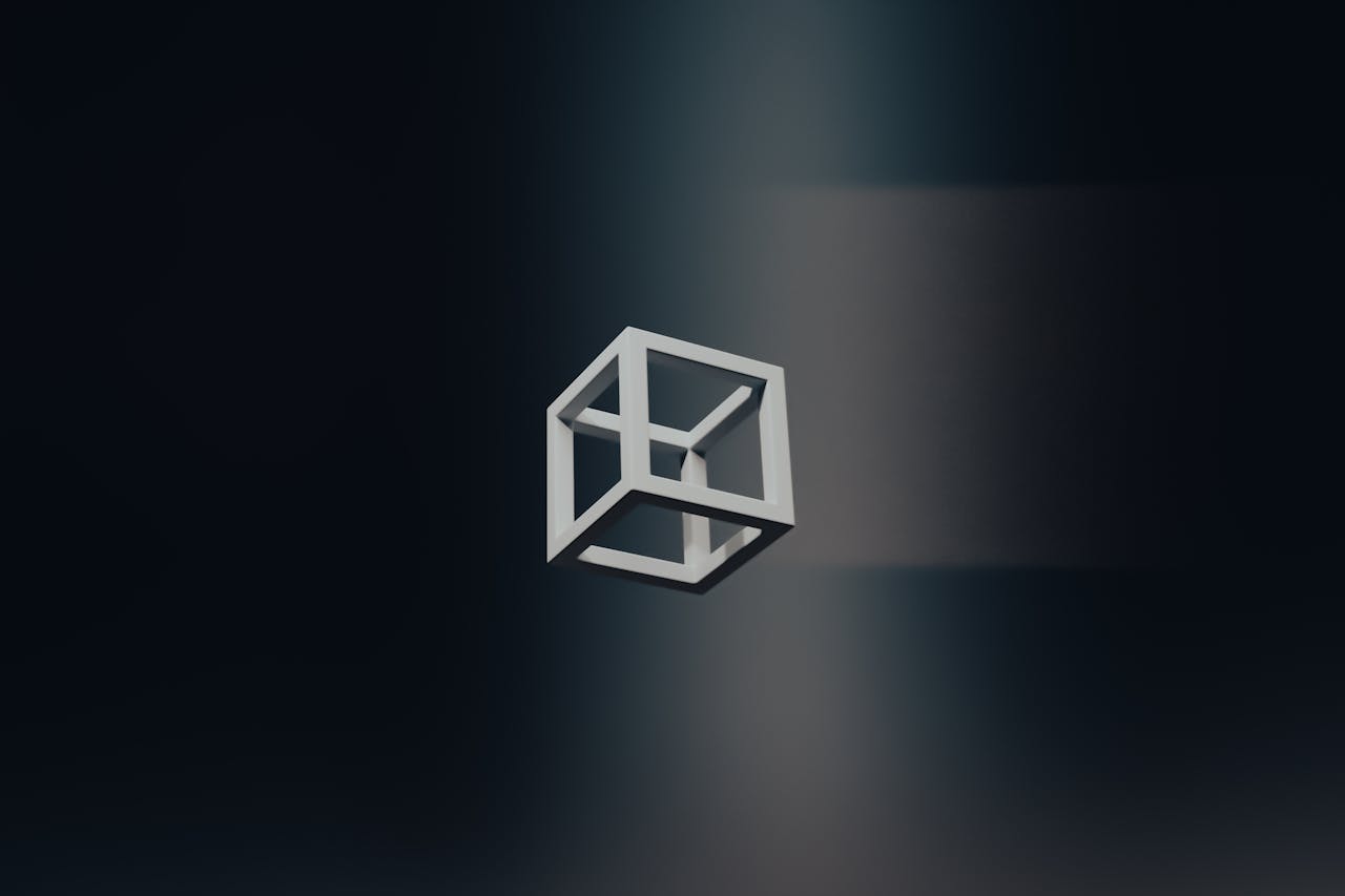 about-us A minimalistic 3D cube floating in a dark space, creating an abstract art theme.